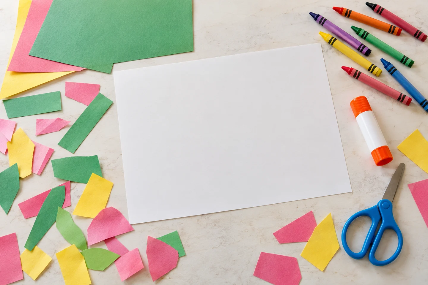 Background paper, colored scraps, crayons, glue and child scissors for a paper garden.