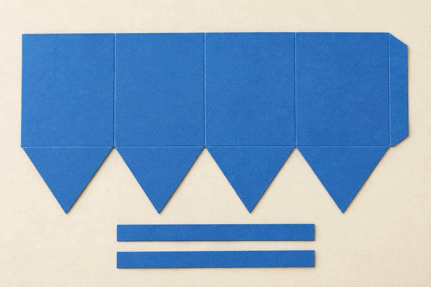 An unlettered flat cut-out net: four connected 1.5-by-2-inch rectangles, a half-inch end joining tab and four downward triangles 1.5 inches high; no diagram labels