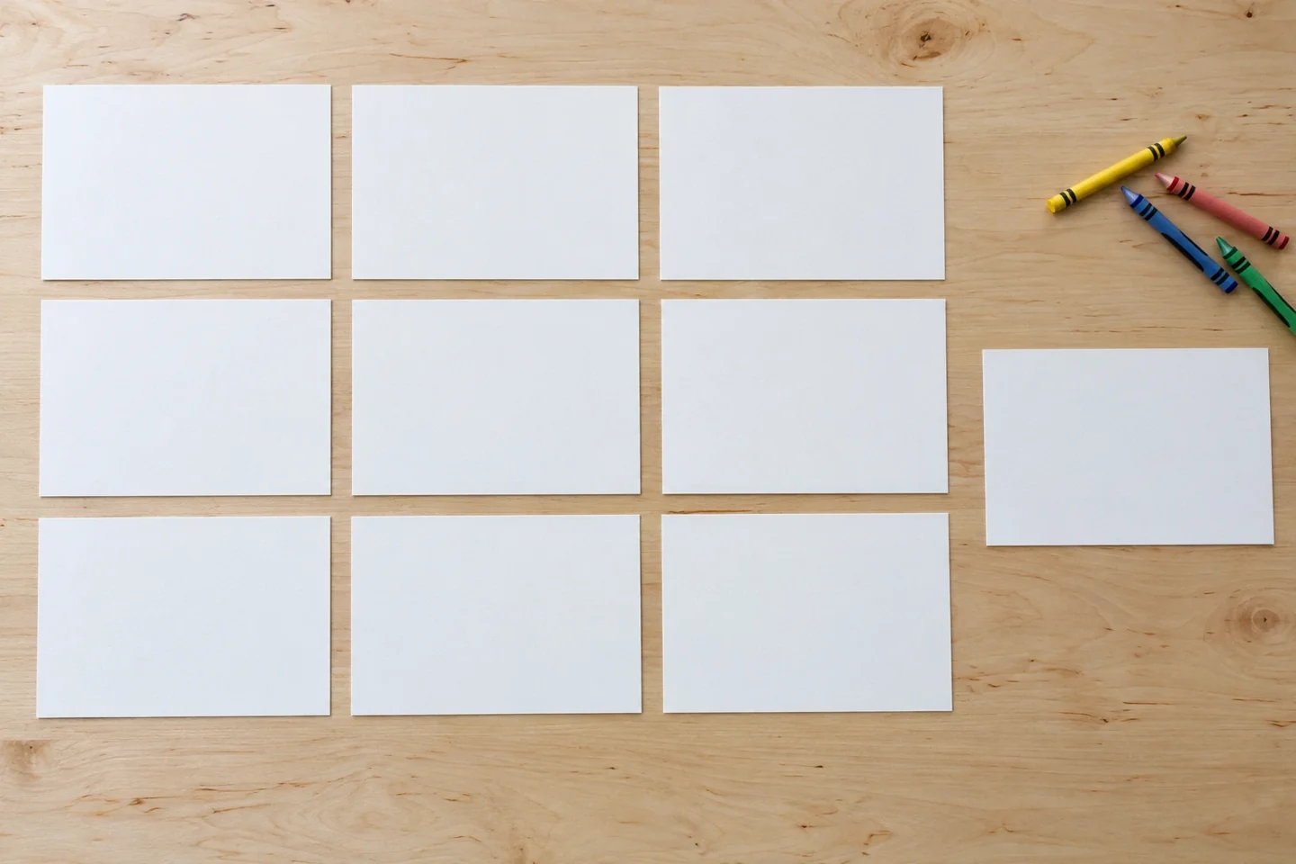 Nine blank half-sheet cards arranged three by three on tabletop