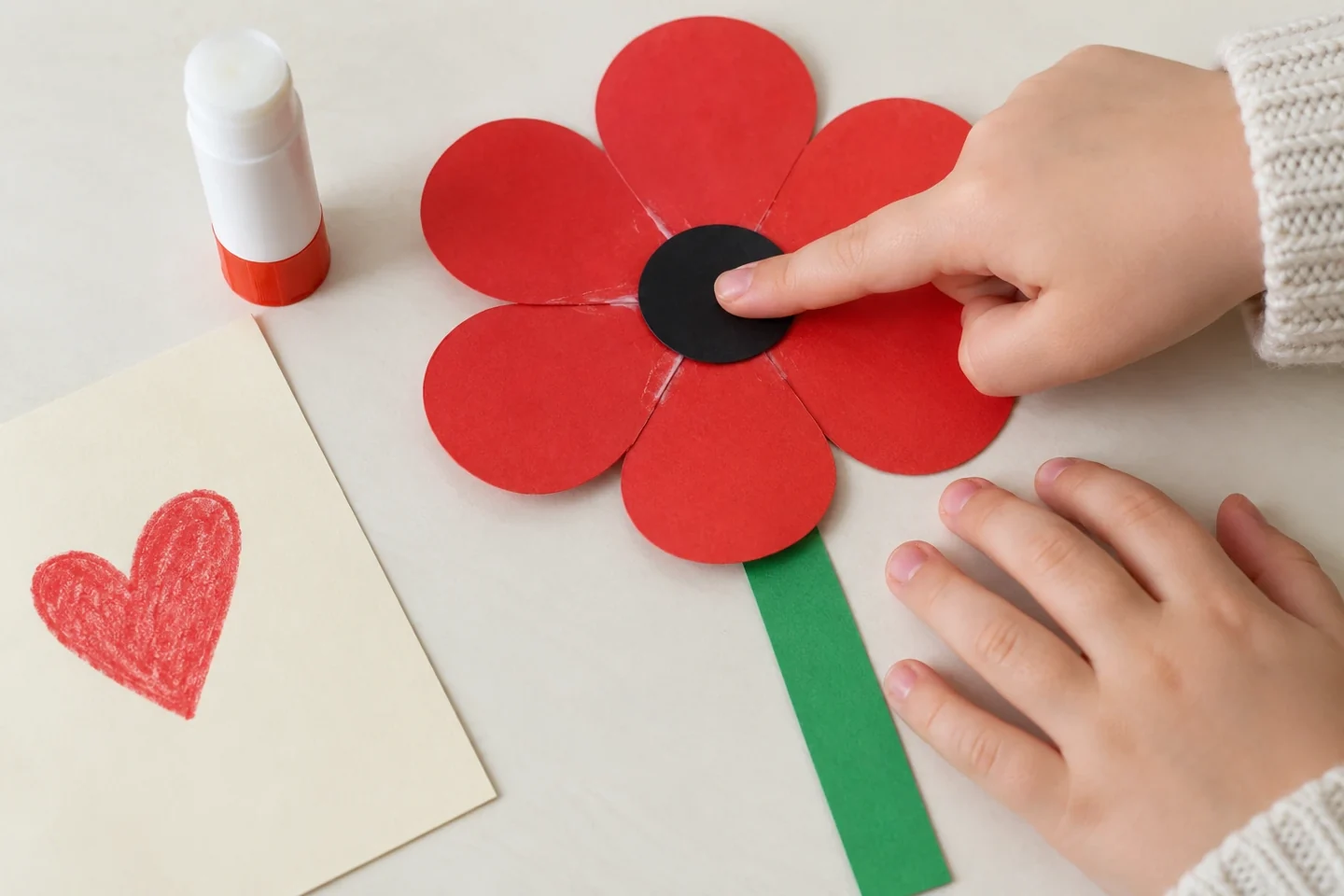 Closeup of dark center circle being pressed onto six joined red petals