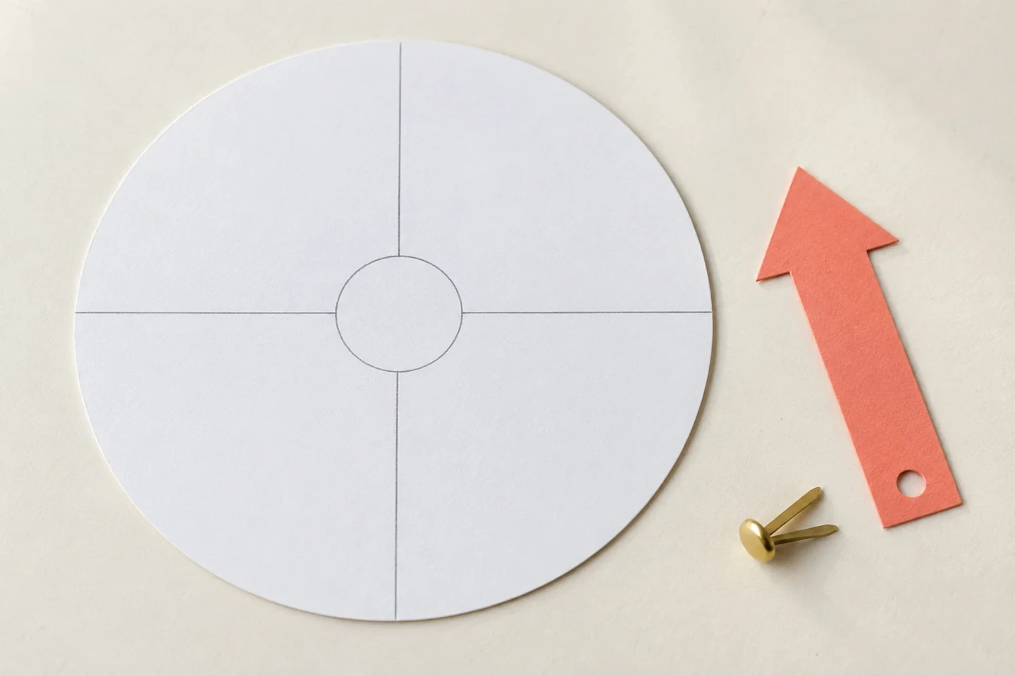 Flat 8-inch circle divided into four equal pencilled sections with empty central 1-inch hub, broad 3.5-inch pointer unjoined alongside