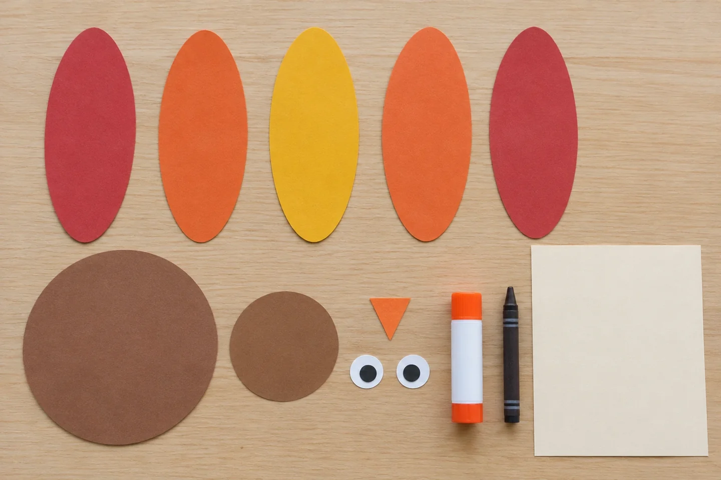 Separate body and head circles, five feather ovals, triangle beak, paper eyes and glue